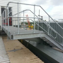 Galvanized rooftop plant access step-over above HVAC and utility services