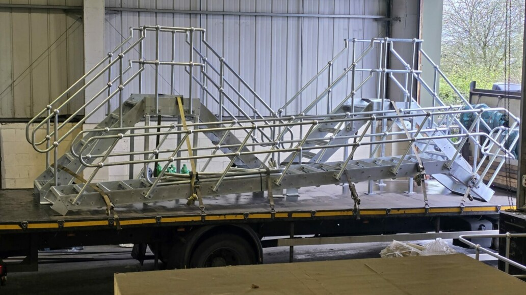 Compact steel plant room step-over with stairs, landing and handrails