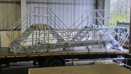 Compact steel plant room step-over with stairs, landing and handrails
